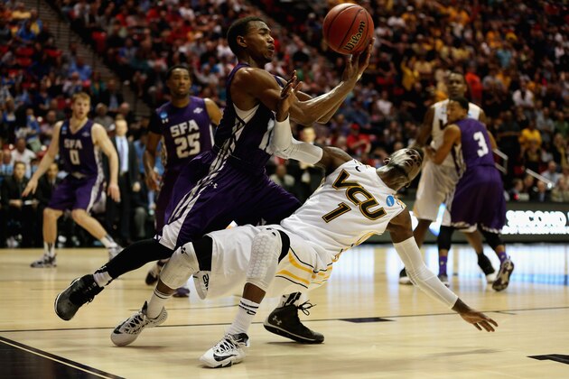 SAN DIEGO, CA - MARCH 21:  JeQuan Lewis #1 of the Virginia Commonwealth Rams is fouled by Trey Pinkney #10 of the Stephen F. Austin Lumberjacks during the second round of the 2014 NCAA Men's Basketball Tournament at Viejas Arena on March 21, 2014 in San Diego, California.  (Photo by Jeff Gross/Getty Images)