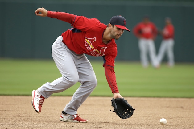 St. Louis Cardinals shortstop Pete Kozma fields a ball while warming up on the field before an exhibition baseball game against the Minnesota Twins that was cancelled due to rain, Thursday, March 6, 2014, in Fort Myers, Fla. (AP Photo/Steven Senne)
