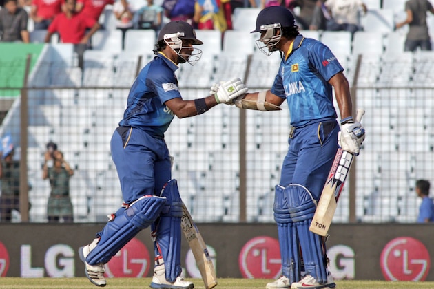 Sri Lanka's Kumar Sangakkara, right, congratulates teammate Kusal Perera for scoring fifty runs during the ICC Twenty20 Cricket World Cup match against South Africa in Chittagong, Bangladesh, Saturday, March 22, 2014. (AP Photo/Bikas Das)