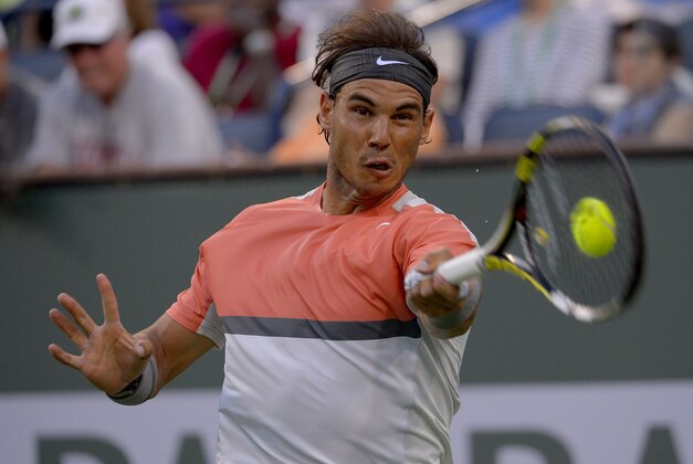 Rafael Nadal, of Spain, hits to Alexandr Dolgopolov, of Ukraine, during a third round match at the BNP Paribas Open tennis tournament, Monday, March 10, 2014 in Indian Wells, Calif. (AP Photo/Mark J. Terrill)