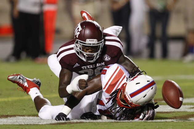 Texas A&M defensive back Deshazor Everett (29) knocks the ball away from SMU wide receiver J'Marcus Rhodes (18) in the fourth quarter during an NCAA college football game Saturday, Sept. 21, 2013, in College Station, Texas. Texas A&M won 42-13. (AP Photo/Bob Levey)