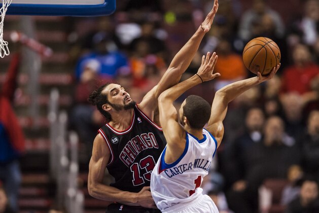 Mar 19, 2014; Philadelphia, PA, USA; Chicago Bulls center Joakim Noah (13) defends the shot of Philadelphia 76ers guard Michael Carter-Williams (1) during the fourth quarter at the Wells Fargo Center. The Bulls defeated the Sixers 102-94. Mandatory Credit: Howard Smith-USA TODAY Sports