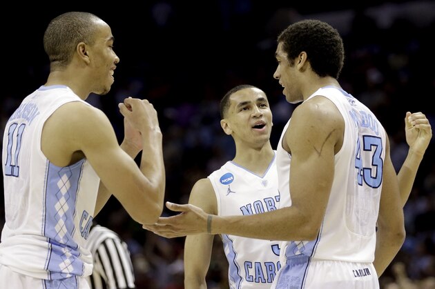 North Carolina's James Michael McAdoo (43) celebrates with teammates Brice Johnson (11), and Marcus Paige (5) after being fouled by Providence in the final seconds of the second half of a second-round game in the NCAA college basketball tournament Friday, March 21, 2014, in San Antonio. McAdoo's free throws lifted North Carolina to a 79-77 win over Providence. (AP Photo/David J. Phillip)