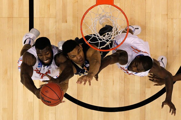 ORLANDO, FL - MARCH 22:  Derrick Randall #11 of the Pittsburgh Panthers attacks the basket defended by Patric Young #4 and Dorian Finney-Smith #10 of the Florida Gators during the third round of the 2014 NCAA Men's Basketball Tournament at Amway Center on March 22, 2014 in Orlando, Florida.  (Photo by Mike Ehrmann/Getty Images)