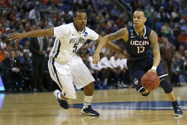 Mar 22, 2014; Buffalo, NY, USA; Connecticut Huskies guard Shabazz Napier (13) drives past Villanova Wildcats guard Tony Chennault (5) in the first half of a men's college basketball game during the third round of the 2014 NCAA Tournament at First Niagara Center. Mandatory Credit: Kevin Hoffman-USA TODAY Sports