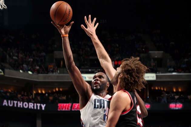 CHARLOTTE, NC - MARCH 22:  Al Jefferson #25 of the Charlotte Bobcats shoots against Robin Lopez #42 of the Portland Trail Blazers at the Time Warner Cable Arena on March 22, 2014 in Charlotte, North Carolina. NOTE TO USER: User expressly acknowledges and agrees that, by downloading and or using this photograph, User is consenting to the terms and conditions of the Getty Images License Agreement.  Mandatory Copyright Notice:  Copyright 2014 NBAE (Photo by Brock Williams-Smith/NBAE via Getty Images)