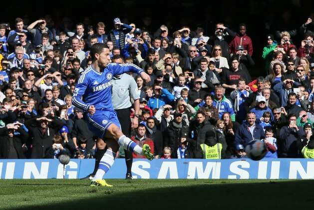 Chelsea's Eden Hazard scores his team's third goal from the penalty spot during their English Premier League soccer match between Chelsea and Arsenal at Stamford Bridge stadium in London Saturday, March,  22  2014. (AP Photo/Alastair Grant)