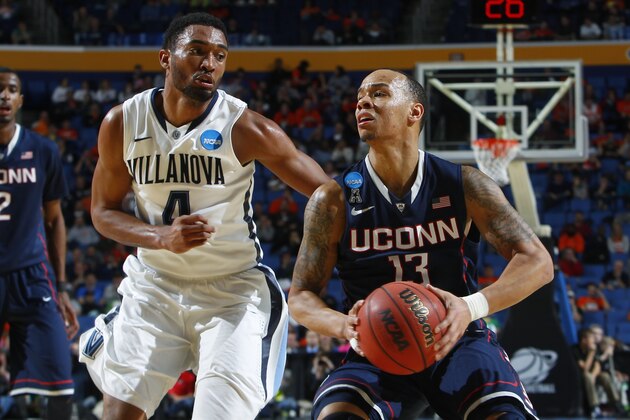 Villanova's Darrun Hilliard II (4) defends Connecticut's Shabazz Napier (13) during the second half of a third-round game in the NCAA men's college basketball tournament in Buffalo, N.Y., Saturday, March 22, 2014. (AP Photo/Bill Wippert)