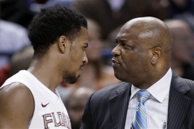Florida State coach Leonard Hamilton, right, stares at Devon Bookert, left, as he walks off the court during the first half of an NCAA college basketball game against Clemson at the Atlantic Coast Conference men's tournament in Greensboro, N.C., Thursday, March 14, 2013. (AP Photo/Bob Leverone)