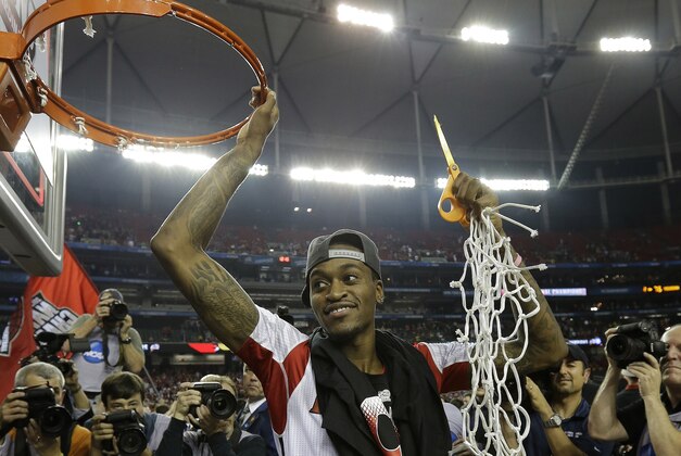 Louisville guard Kevin Ware holds the net after Louisville defeated Michigan 82-76 after the second half of the NCAA Final Four tournament college basketball championship game Tuesday, April 9, 2013, in Atlanta. (AP Photo/David J. Phillip)
