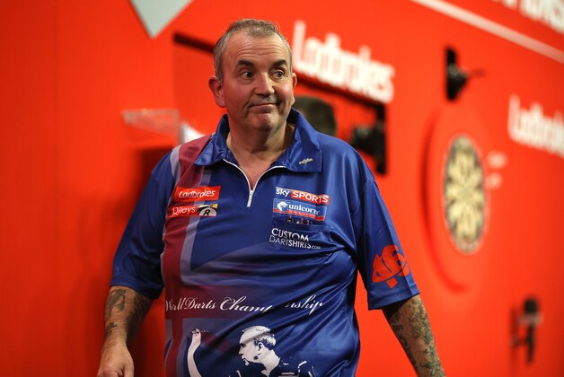 LONDON, ENGLAND - DECEMBER 20: Phil Taylor of England reacts as he walks off the stage after losing his second round match to Michael Smith of England during the Ladbrokes.com World Darts Championship on Day Eight at Alexandra Palace on December 20, 2013 in London, England. (Photo by Charlie Crowhurst/Getty Images)