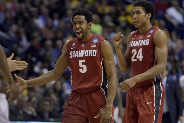 Stanford's Chasson Randle, left, and Josh Huestis celebrate during the second half of a third-round game against Kansas of the NCAA college basketball tournament Sunday, March 23, 2014, in St. Louis. (AP Photo/Jeff Roberson)