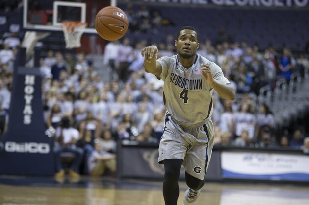Georgetown guard D'Vauntes Smith-Rivera (4) passes the ball during the first half of an NCAA basketball game against Creighton on Tuesday, March 4, 2014, in Washington. (AP Photo/ Evan Vucci)