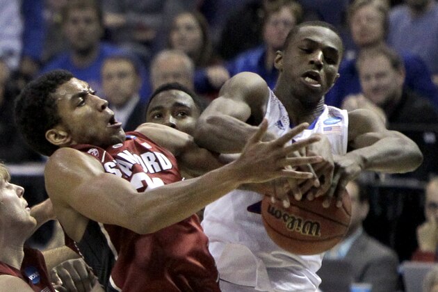 Kansas' Andrew Wiggins, right, and Stanford's Josh Huestis reach for a rebound during the first half of a third-round game of the NCAA college basketball tournament Sunday, March 23, 2014, in St. Louis. (AP Photo/Jeff Roberson)