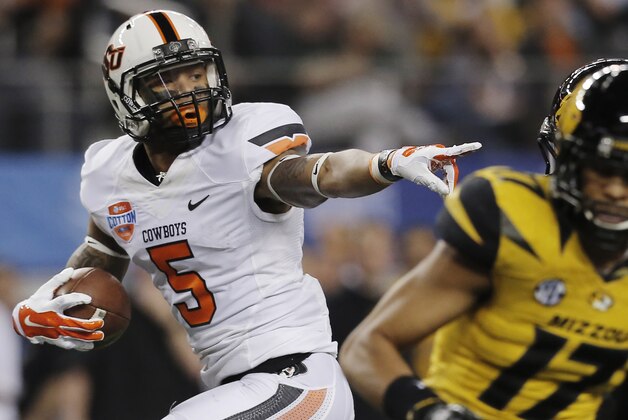 Oklahoma State wide receiver Josh Stewart (5) gestures on his way in for a touchdown against Oklahoma State during the first half of the Cotton Bowl NCAA college football game on Friday, Jan. 3, 2014, in Arlington, Texas. (AP Photo/Brandon Wade)