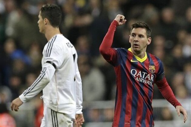 FC Barcelona's Lionel Messi from Argentina, right celebrates next to Real Madrid's Cristiano Ronaldo after scoring his team's 2nd goal during a Spanish La Liga soccer match at the Santiago Bernabeu stadium in Madrid, Sunday March 23, 2014. (AP Photo/Paul White)