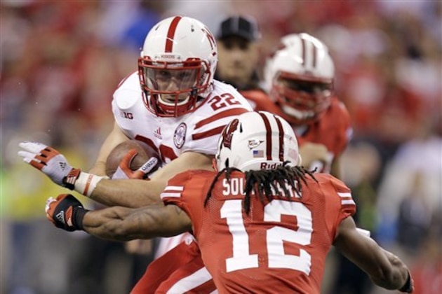 Nebraska running back Rex Burkhead protects the ball against Wisconsin defensive back Dezmen Southward (12) during the first half of the Big Ten championship NCAA college football game Saturday, Dec. 1, 2012, in Indianapolis. (AP Photo/Michael Conroy)