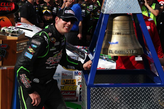 FONTANA, CA - MARCH 23:  Kyle Busch, driver of the #18 Interstate Batteries Toyota, celebrates in Victory Lane after winning the NASCAR Sprint Cup Series Auto Club 400 at Auto Club Speedway on March 23, 2014 in Fontana, California.  (Photo by Todd Warshaw/Getty Images)