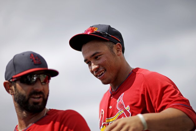 St. Louis Cardinalss' Kolten Wong, right, and Daniel Descalso play in an exhibition spring training baseball game against the Washington Nationals, Friday, March 21, 2014, in Jupiter, Fla. (AP Photo/David Goldman)