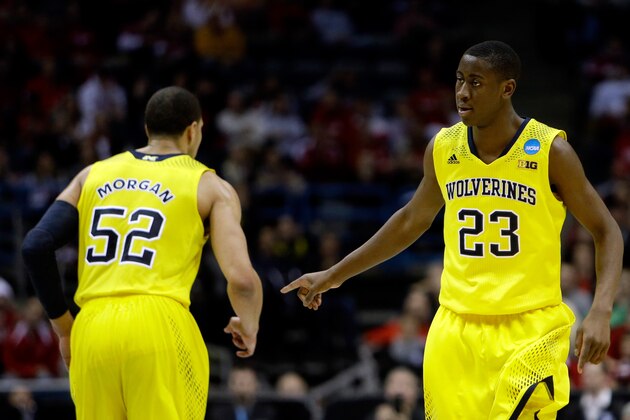 MILWAUKEE, WI - MARCH 22:  Caris LeVert #23 of the Michigan Wolverines celebrates with teammate Jordan Morgan #52 after making a three point shot in the second half against the Texas Longhorns during the third round of the 2014 NCAA Men's Basketball Tournament at BMO Harris Bradley Center on March 22, 2014 in Milwaukee, Wisconsin.  (Photo by Mike McGinnis/Getty Images)