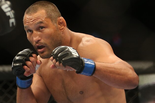 Jun 15, 2013; Winnipeg, MB, Canada; Dan Henderson fights Rashad Evans (left) during their Light Heavyweight bout at UFC 161 at MTS Centre. Mandatory Credit: Tom Szczerbowski-USA TODAY Sports
