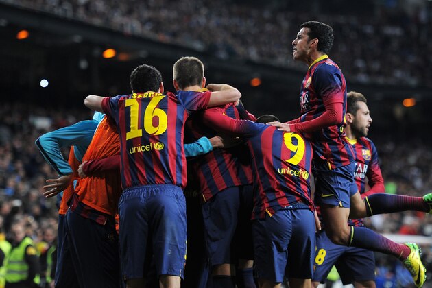 MADRID, SPAIN - MARCH 23: Lionel Messi of Barcelona is mobbed by team mates after scoring his team's fourth goal during the La Liga match between Real Madrid CF and FC Barcelona at the Bernabeu on March 23, 2014 in Madrid, Spain. (Photo by Denis Doyle/Getty Images) MADRID, SPAIN - MARCH 23: Lionel Messi of Barcelona is mobbed by team mates after scoring his team's fourth goal during the La Liga match between Real Madrid CF and FC Barcelona at the Bernabeu on March 23, 2014 in Madrid, Spain. (Photo by Denis Doyle/Getty Images)