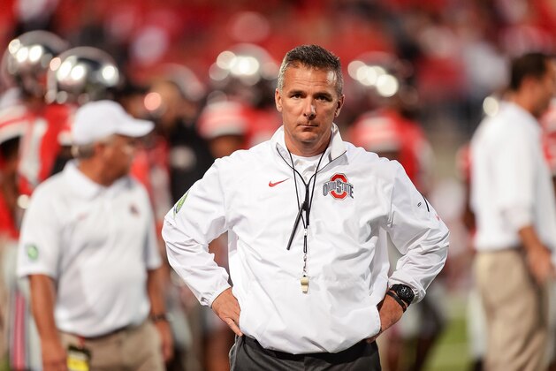 COLUMBUS, OH - SEPTEMBER 28:  Head Coach Urban Meyer of the Ohio State Buckeyes watches his team warm up before a game against the Wisconsin Badgers at Ohio Stadium on September 28, 2013 in Columbus, Ohio.  (Photo by Jamie Sabau/Getty Images)