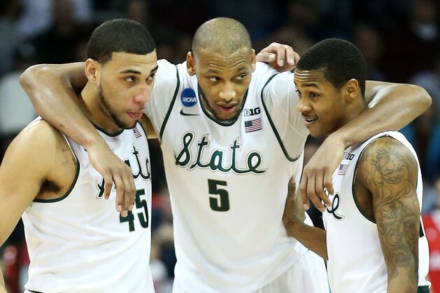 SPOKANE, WA - MARCH 22:  Denzel Valentine #45 Adreian Payne #5 and Keith Appling #11 of the Michigan State Spartans celebrate in the second half of their 80 to 73 win over the Harvard Crimson during the Third Round of the 2014 NCAA Basketball Tournament at Spokane Veterans Memorial Arena on March 22, 2014 in Spokane, Washington.  (Photo by Stephen Dunn/Getty Images)