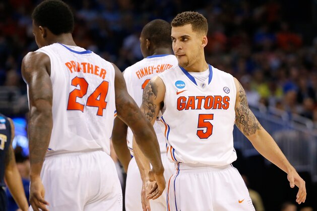 ORLANDO, FL - MARCH 22:  Scottie Wilbekin #5 of the Florida Gators reacts with Casey Prather #24 after making a three-pointer in the second half against the Pittsburgh Panthers in the second half during the third round of the 2014 NCAA Men's Basketball Tournament at Amway Center on March 22, 2014 in Orlando, Florida.  (Photo by Kevin C. Cox/Getty Images)
