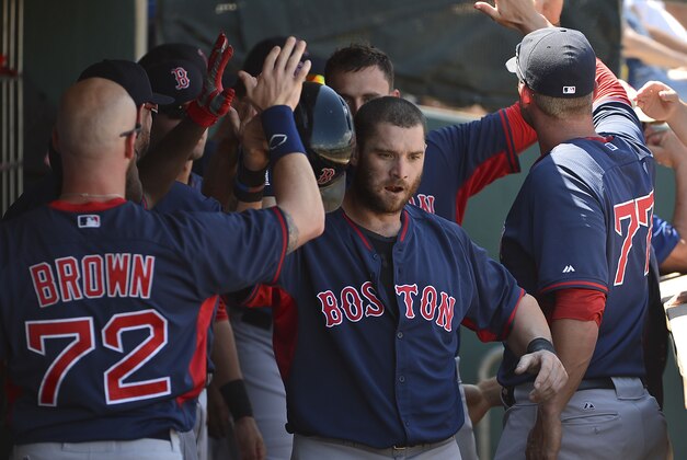 Mar 21, 2014; Clearwater, FL, USA; Boston Red Sox left fielder Jonny Gomes (center) celebrates with his teammates after scoring in the sixth inning against the Philadelphia Phillies at Bright House Field. Mandatory Credit: Tommy Gilligan-USA TODAY Sports
