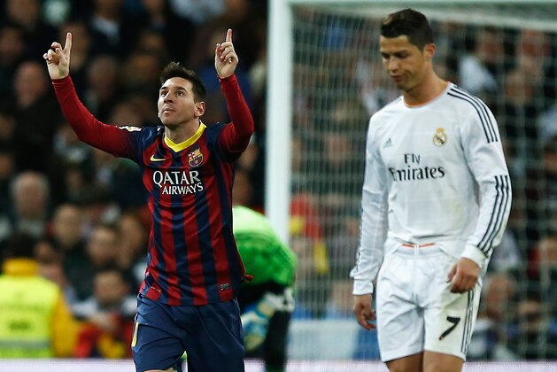 MADRID, SPAIN - MARCH 23:  Lionel Messi of Barcelona celebrates scoring his team's third goal as Cristiano Ronaldo of Real Madrid looks dejected during the La Liga match between Real Madrid CF and FC Barcelona at the Bernabeu on March 23, 2014 in Madrid, Spain.  (Photo by Gonzalo Arroyo Moreno/Getty Images)