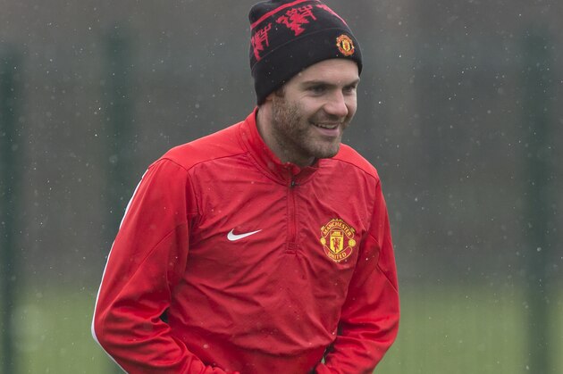 Manchester United's Juan Mata trains with teammates at Carrington training ground in Manchester, Tuesday, March 18, 2014. Manchester United will play Olympiakos in a Champions League last 16 second leg soccer match on Wednesday. (AP Photo/Jon Super)
