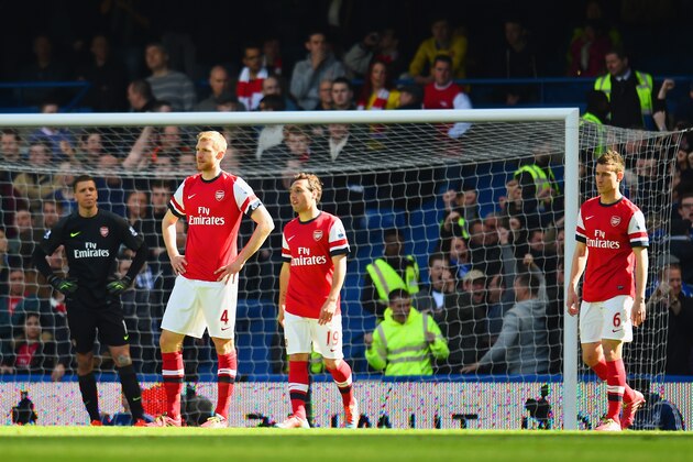 LONDON, ENGLAND - MARCH 22:  A dejected Per Mertesacker, Santi Cazorla and Laurent Koscielny of Arsenal after conceding the second goal during the Barclays Premier League match between Chelsea and Arsenal at Stamford Bridge on March 22, 2014 in London, England.  (Photo by Shaun Botterill/Getty Images)