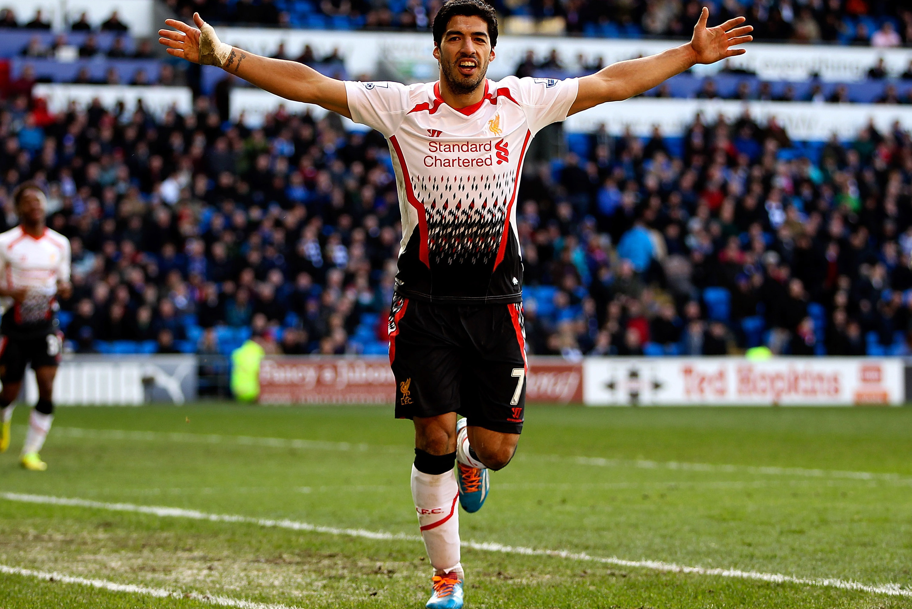 CARDIFF, WALES - MARCH 22:  Luis Suarez of Liverpool celebrates after scoring hihs third and his team's sixth goal of the game during the Barclays Premier League match between Cardiff City and Liverpool at Cardiff City Stadium on March 22, 2014 in Cardiff, Wales.  (Photo by Ben Hoskins/Getty Images)