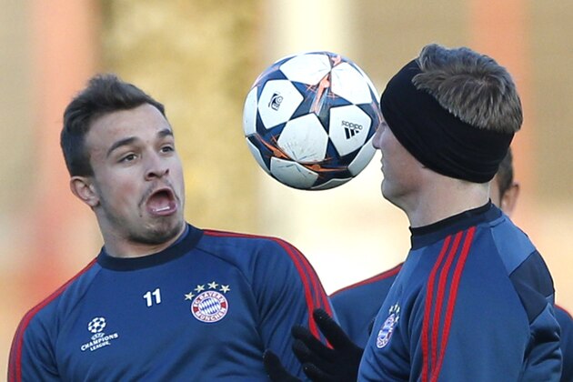 Bayern's Xherdan Shaqiri of Switzerland, left, and Bastian Schweinsteiger challenge for the ball during a training session in Munich, southern Germany, Monday, March 10, 2014, ahead of their round of 16 second leg Champions League soccer match against Arsenal London on Wednesday. (AP Photo/Matthias Schrader)