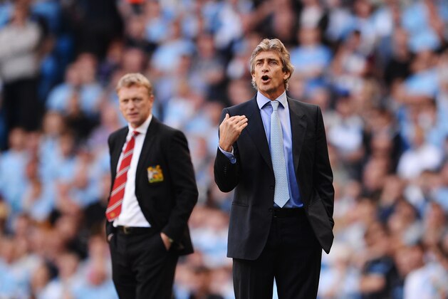 MANCHESTER, ENGLAND - SEPTEMBER 22:  David Moyes manager of Manchester United (L) and Manuel Pellegrini manager of Manchester City look on during the Barclays Premier League match between Manchester City and Manchester United at the Etihad Stadium on September 22, 2013 in Manchester, England.  (Photo by Michael Regan/Getty Images)