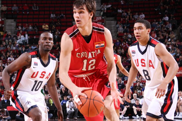 PORTLAND, OR - APRIL 7: Dario Saric #12 of the World Select Team drives against Shabazz Muhammad #10 and James Robinson #8 of the USA Junior Select Team during the 2012 Hoop Summit on April 7, 2012 at the Rose Garden Arena in Portland, Oregon. NOTE TO USER: User expressly acknowledges and agrees that, by downloading and or using this photograph, User is consenting to the terms and conditions of the Getty Images License Agreement. Mandatory Copyright Notice: Copyright 2012 NBAE (Photo by Sam Forencich/NBAE via Getty Images)