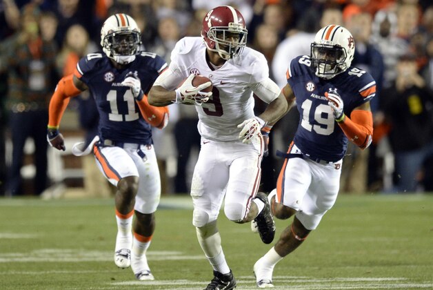 Nov 30, 2013; Auburn, AL, USA; Alabama Crimson Tide wide receiver Amari Cooper (9) runs after a reception against Auburn Tigers cornerback Chris Davis (11) and defensive back Ryan White (19) during the third quarter at Jordan Hare Stadium. Mandatory Credit: John David Mercer-USA TODAY Sports