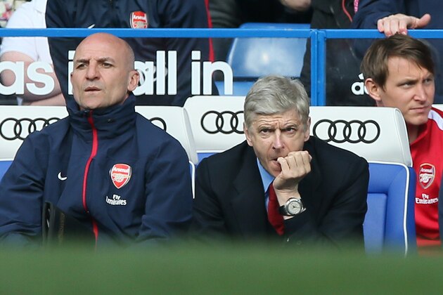 Arsenal's manager Arsene Wenger, left, watches his team play during their English Premier League soccer match between Chelsea and Arsenal at Stamford Bridge stadium in London, Saturday, March, 22,  2014. Chelsea defeated Arsenal 6-0. (AP Photo/Alastair Grant)