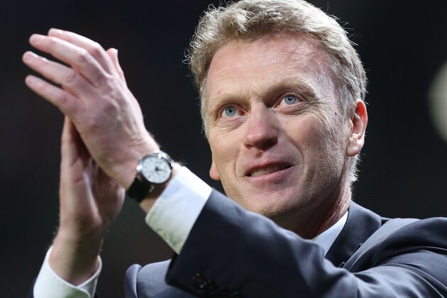 Manchester United manager David Moyes celebrates after his team's 3-0 Champions League last 16 second leg soccer match win against Olympiacos at Old Trafford Stadium, Manchester, England, Wednesday, March 19, 2014. (AP Photo/Jon Super)