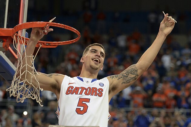 Florida guard Scottie Wilbekin (5) holds up a piece of the net after the Gators became the first team in Southeastern Conference history to go 18-0 in league pla, Saturday, March 8, 2014 in Gainesville, Fla.    Florida defeated Kentucky 84-65 Saturday in an NCAA college basketball game. (AP Photo/Phil Sandlin)