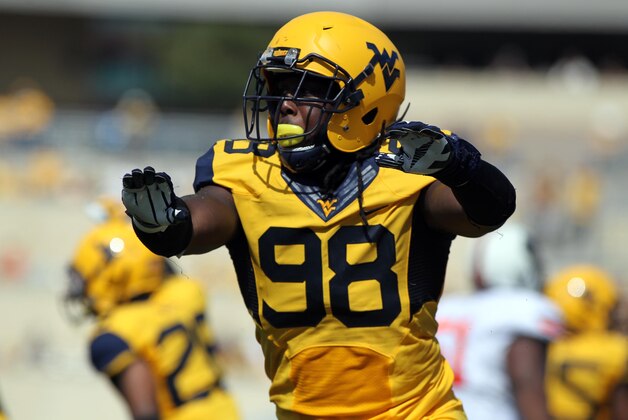 Sep 28, 2013; Morgantown, WV, USA; West Virginia Mountaineers defensive lineman Will Clarke (98) celebrates after a stop during the first half against the Oklahoma State Cowboys at Milan Puskar Stadium. Mandatory Credit: Peter Casey-USA TODAY Sports