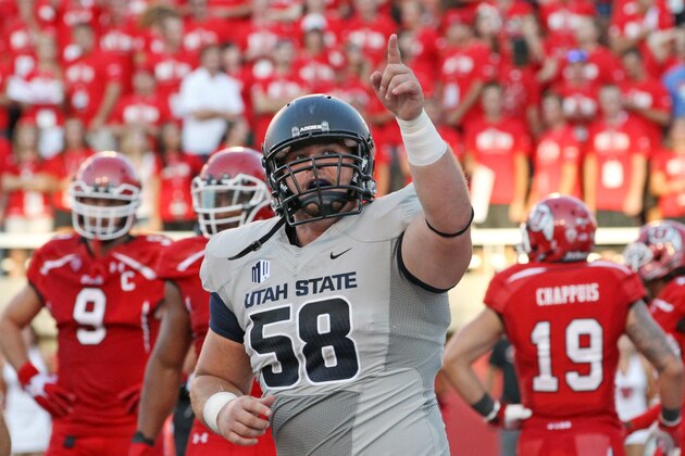 Utah State's Tyler Larsen (58) celebrates after his team scores in the second quarter during an NCAA football game against Utah Thursday, Aug. 29, 2013, in Salt Lake City.  (AP Photo/Rick Bowmer)