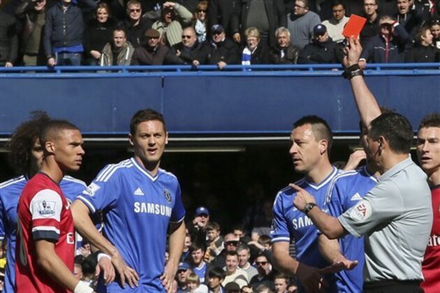 Referee Andre Marriner, in grey, sends off Arsenal's Kieran Gibbs, left, during their English Premier League soccer match between Chelsea and Arsenal at Stamford Bridge stadium in London Saturday, Mar  22  2014. (AP Photo/Alastair Grant)