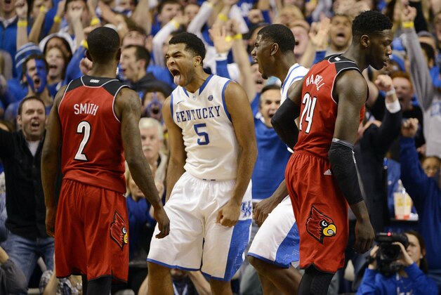 Dec 28, 2013; Lexington, KY, USA; Kentucky Wildcats guard Andrew Harrison (5) and forward Alex Poythress (22) react during the second half against the Louisville Cardinals at Rupp Arena. Kentucky defeated Louisville 73-66.  Mandatory Credit: Jamie Rhodes-USA TODAY Sports