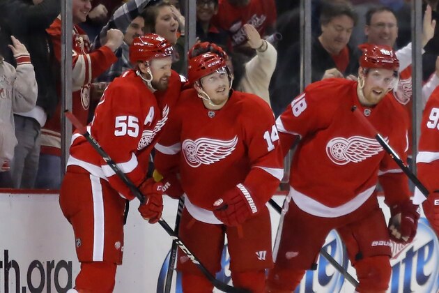 Detroit Red Wings' Gustav Nyquist (14) is congratulated by teammates Niklas Kronwall (55) and Joakim Andersson (18), all of Sweden, during the first period of an NHL hockey game against the Minnesota Wild Sunday, March 23, 2014 in Detroit. (AP Photo/Duane Burleson)