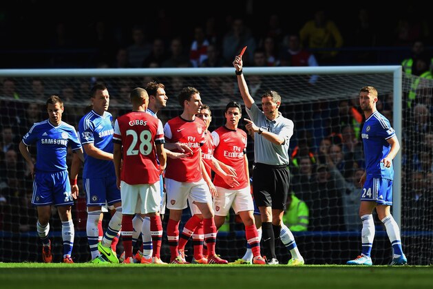 LONDON, ENGLAND - MARCH 22:  Referee Andre Marriner shows Kieran Gibbs of Arsenal a red card during the Barclays Premier League match between Chelsea and Arsenal at Stamford Bridge on March 22, 2014 in London, England.  (Photo by Shaun Botterill/Getty Images)