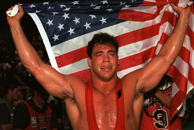 Kurt Angle of the United States celebrates his gold medal in the 100 kg class of freestyle wrestling at the Centennial Olympic Games in Atlanta Wednesday July 31, 1996.  Angle defeated Abbas Jadidi of Iran.  (AP Photo/Michel Lipchitz)