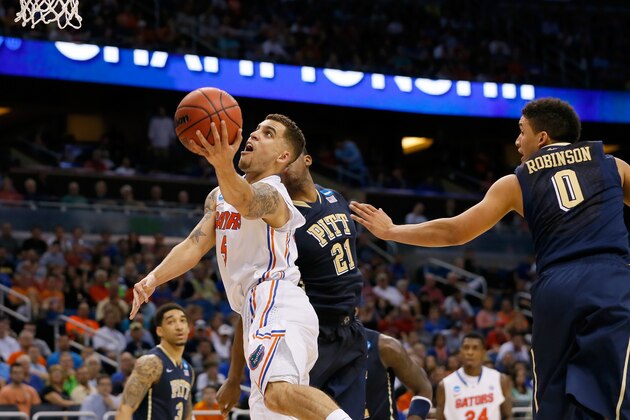ORLANDO, FL - MARCH 22:  Scottie Wilbekin #5 of the Florida Gators goes up for a shot against James Robinson #0 and Lamar Patterson #21 of the Pittsburgh Panthers in the second half during the third round of the 2014 NCAA Men's Basketball Tournament at Amway Center on March 22, 2014 in Orlando, Florida.  (Photo by Kevin C. Cox/Getty Images)