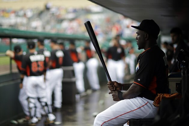Miami Marlins' Marcell Ozuna sits in the dugout while watching an exhibition spring training baseball game against the Washington Nationals, Monday, March 24, 2014, in Jupiter, Fla. (AP Photo/David Goldman) Miami Marlins' Marcell Ozuna sits in the dugout while watching an exhibition spring training baseball game against the Washington Nationals, Monday, March 24, 2014, in Jupiter, Fla. (AP Photo/David Goldman)